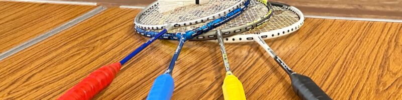 four badminton rackets and a shuttlecock